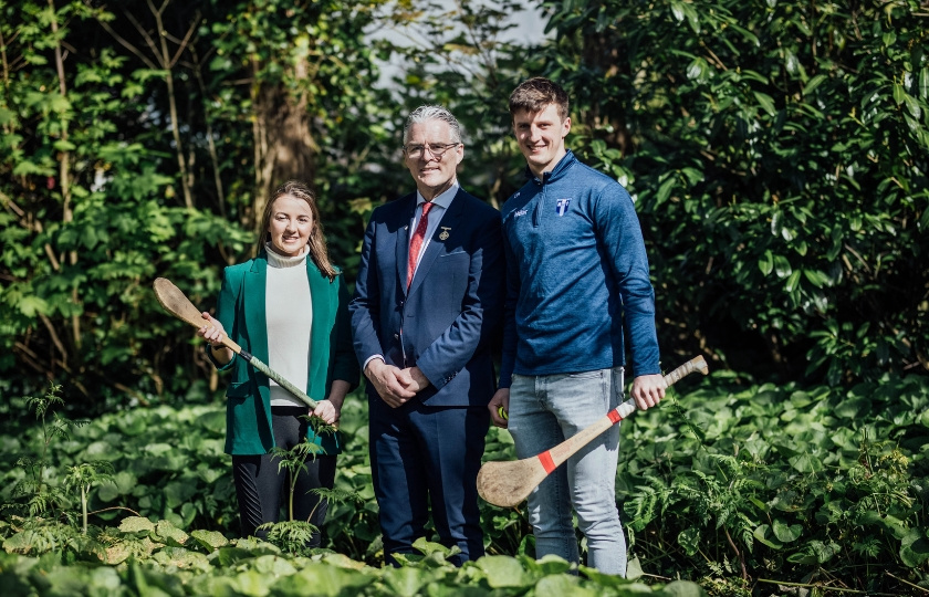 President Jarlath Burns with MIC GPA Scholar Diarmuid Ryan and previous Scholar, Caoimhe Costello in a wooded area