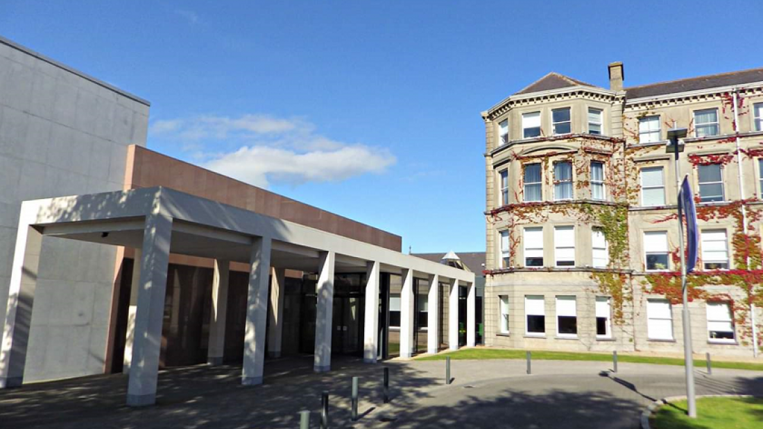 A large 19th century building with a modern extension.