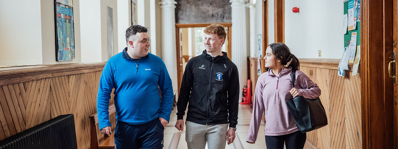 Three undergraduate students in the hallway of MIC Thurles