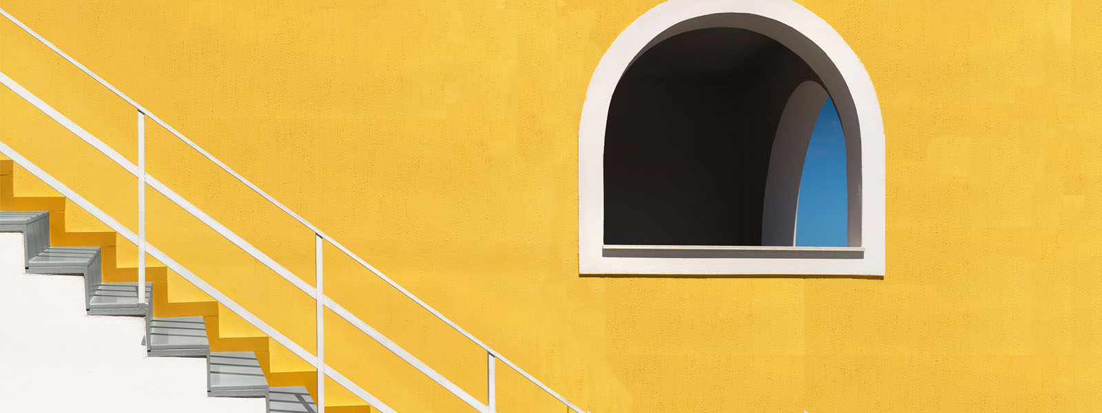 Yellow wall, stairs and open window