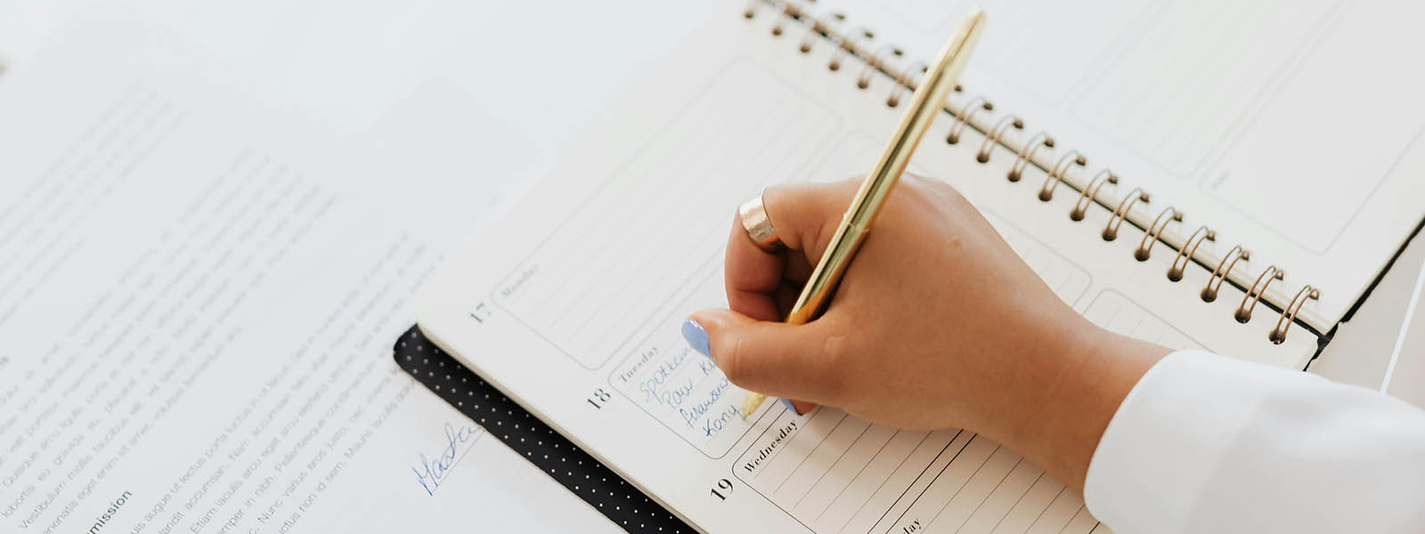 Person writing in calendar diary