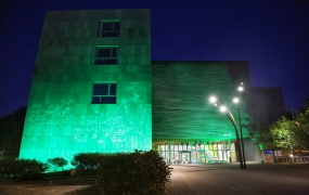 TARA Building on MIC Limerick campus lit up in green 