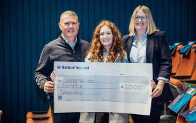 Entrance scholar with parents and oversized cheque at MIC College Awards 2024