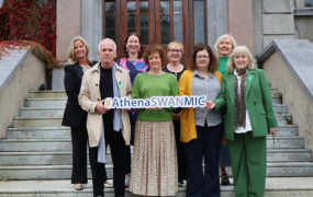 A group of people posing for a photo for an Athena Swan award