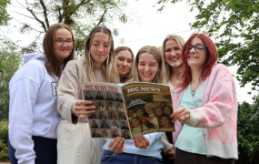 Students with a student newspaper