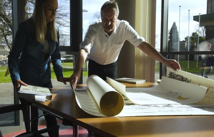 two postgraduate students at MIC looking over charts 