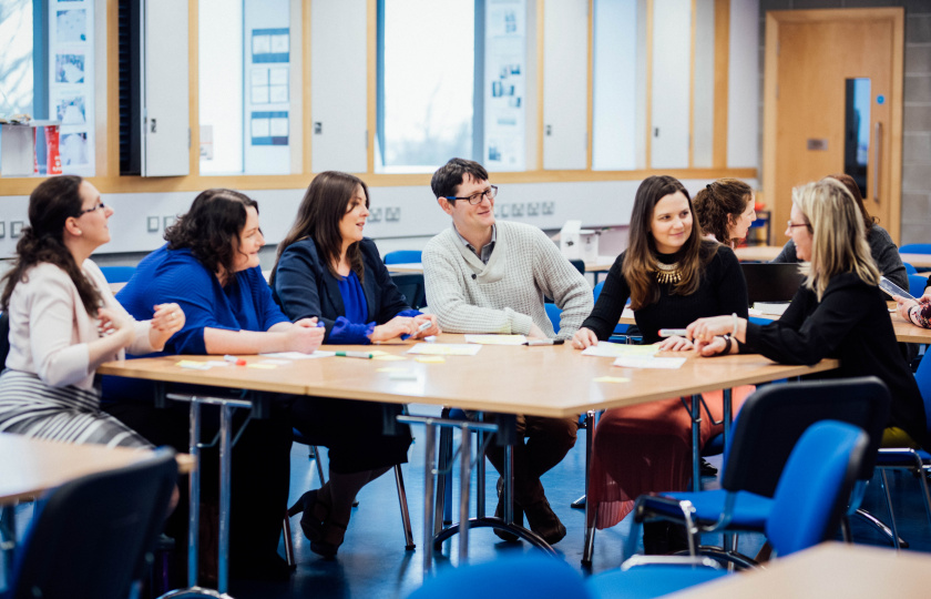 Adults sitting around a table in an MIC Classroom