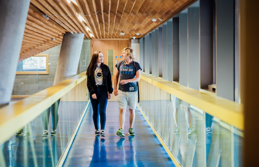 Image of MIC students walking along a corridor