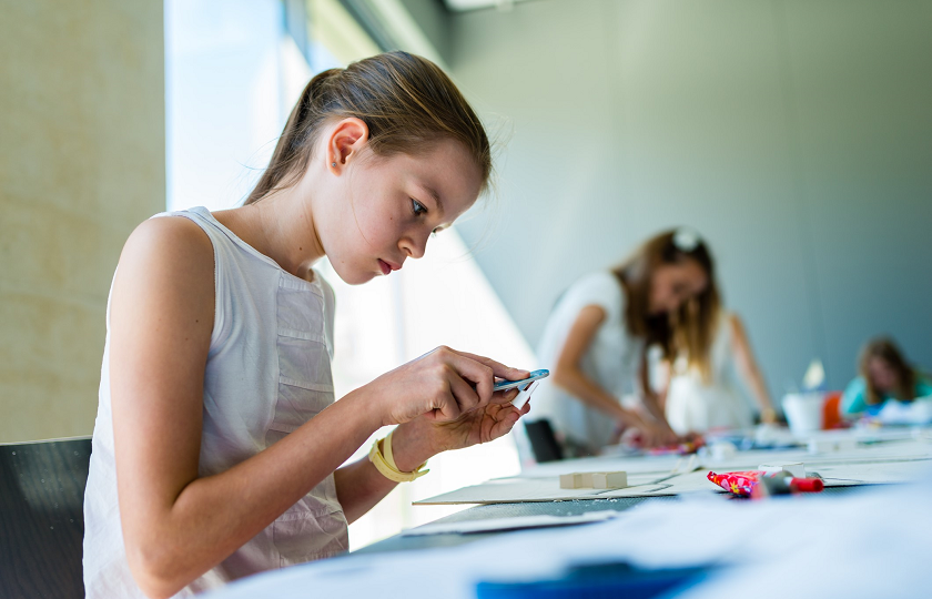 Young girl sitting at table