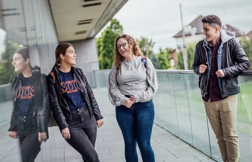 MIC students talking on the Tailteann balcony on MIC Limerick campus