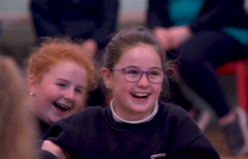 Two school children laughing