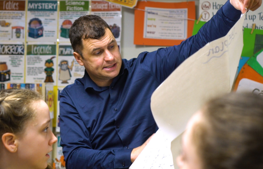 Teacher showing presentation to two children