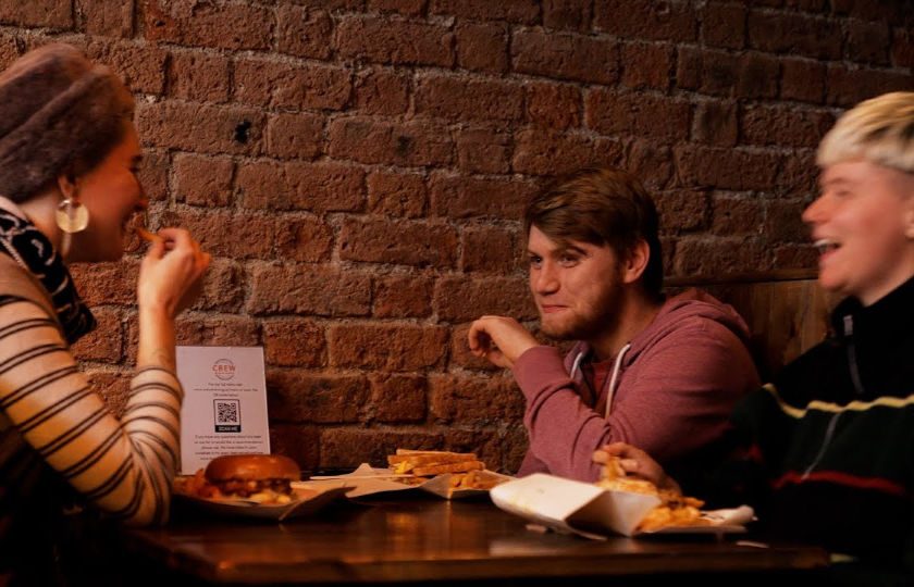 Three students enjoying a meal