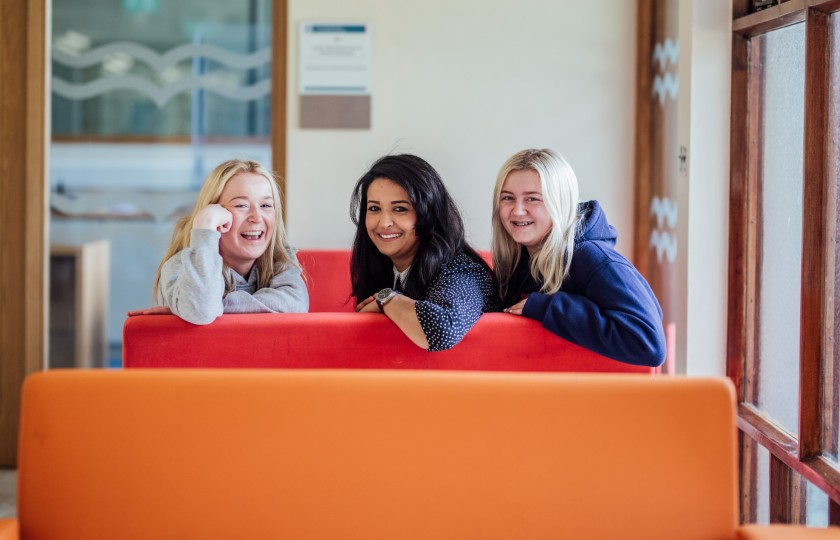 Three students on couches