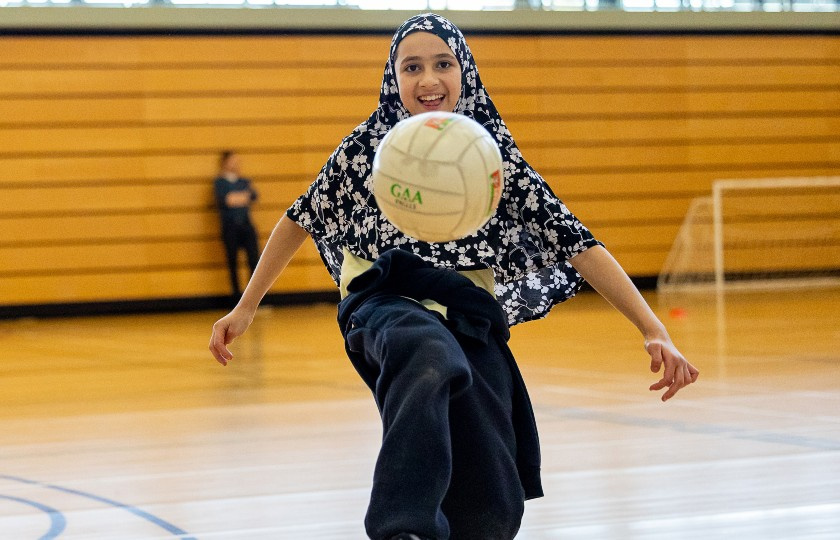 Scoil Mháthair Dé student Asiyah Nasiry plays with a football at the GAA Centre of Excellence launch.