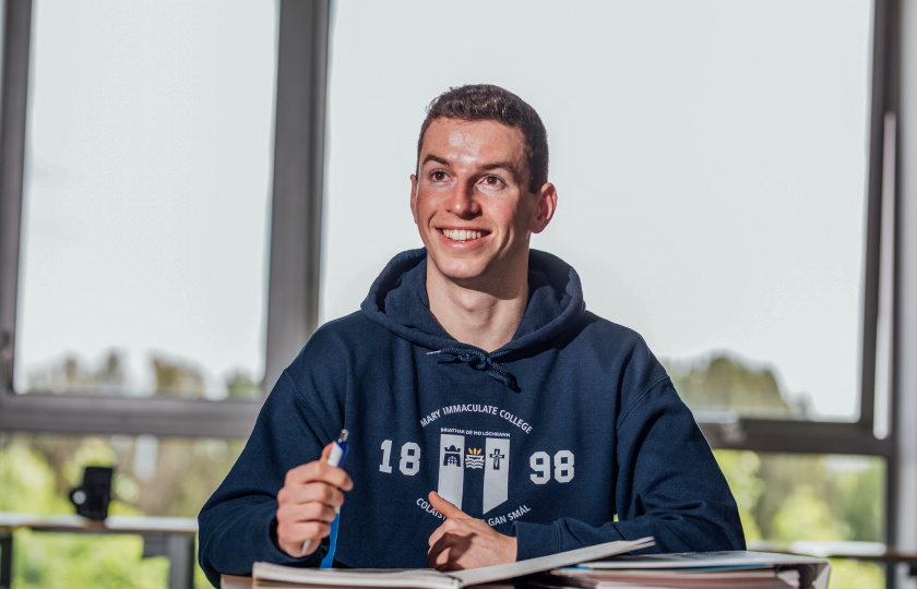 Male student sitting at desk