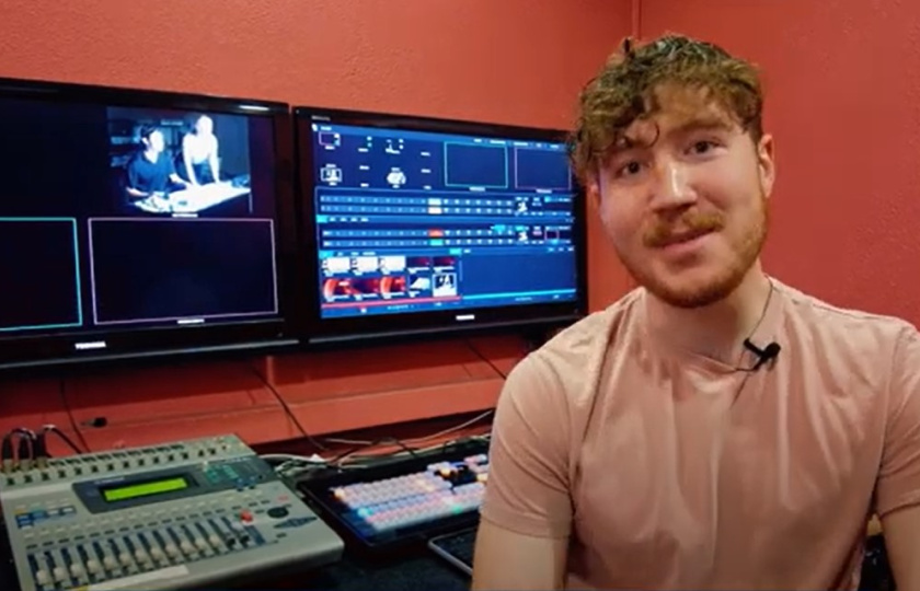 MIC media student sitting at production desk 