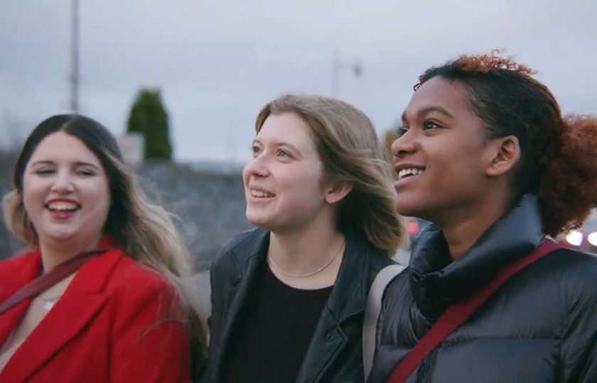 Three female students walking together outside