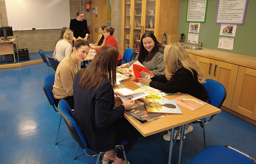 Students sitting at a table in a classroom.