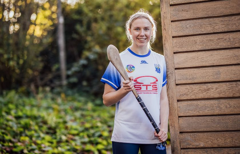 Niamh Murphy in a Waterford jersey holding a hurley