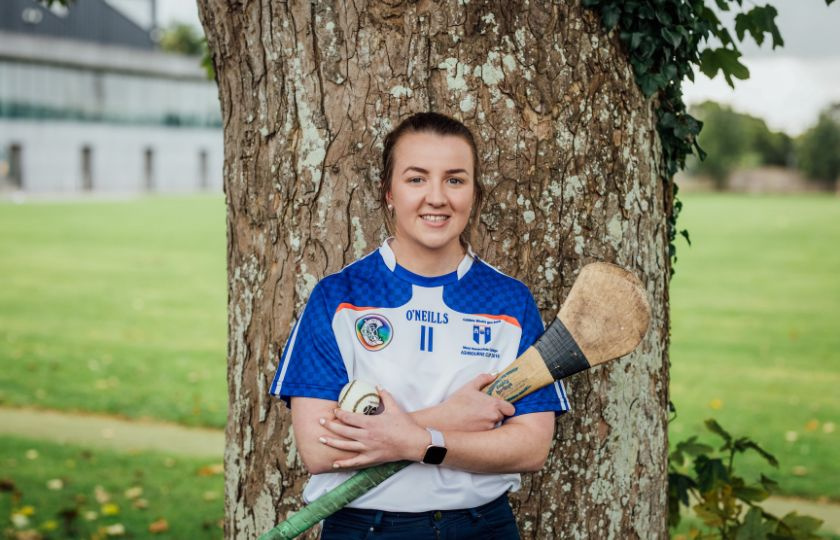 Caoimhe Costelloe in an MIC jersey holding a hurley