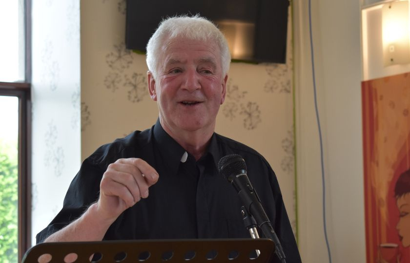 Fr Michael Wall speaking at a microphone