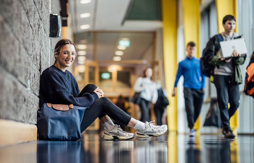 Female student sitting in hallway on MIC Limerick campus.