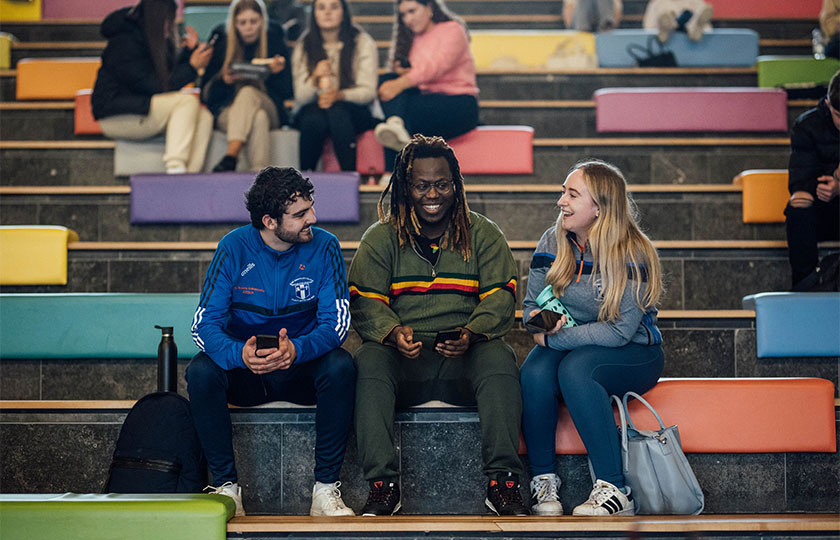 Students sitting on the steps in the TARA building