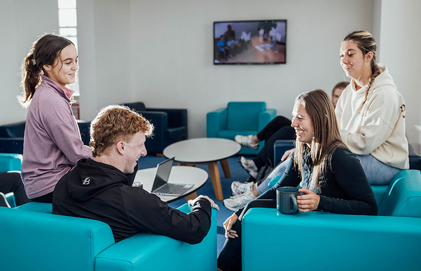 Students sitting in the common area in student accommodation.