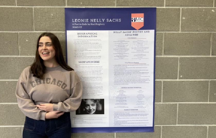 Student Kaci standing beside her poster on the life of Nelly Sachs (1981-1970)