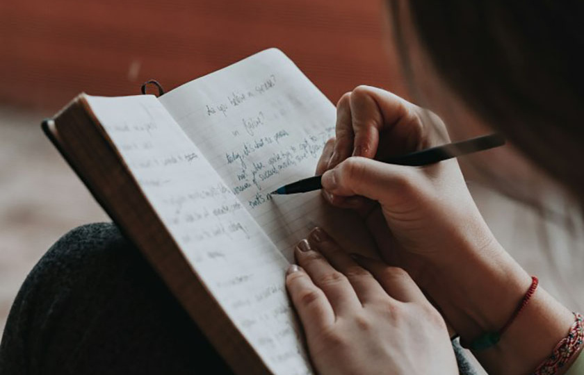 Woman writing in her journal