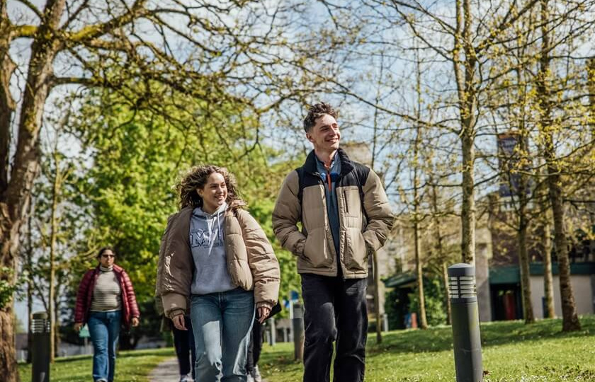 Female and male MIC students walking through MIC Limerick campus