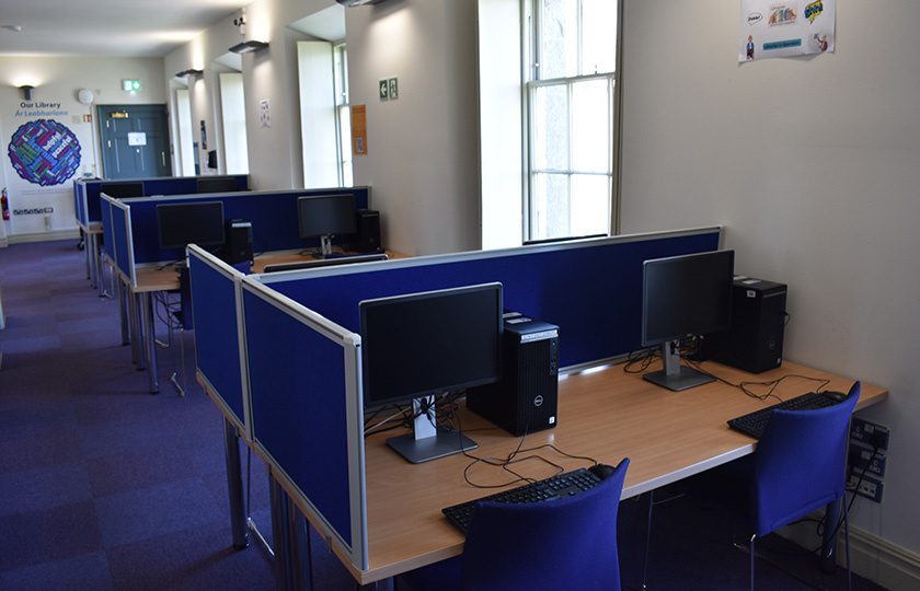 A series of unoccupied computer workstations.