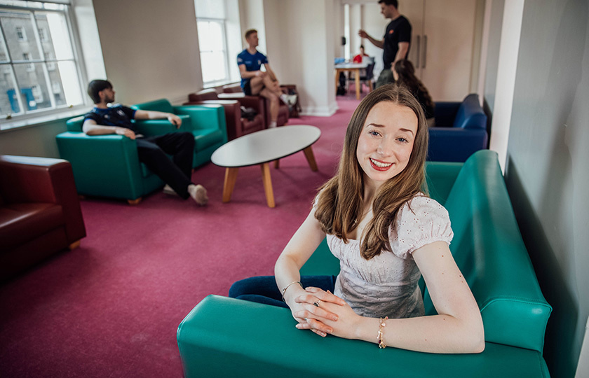 A student sitting in the student lounge.