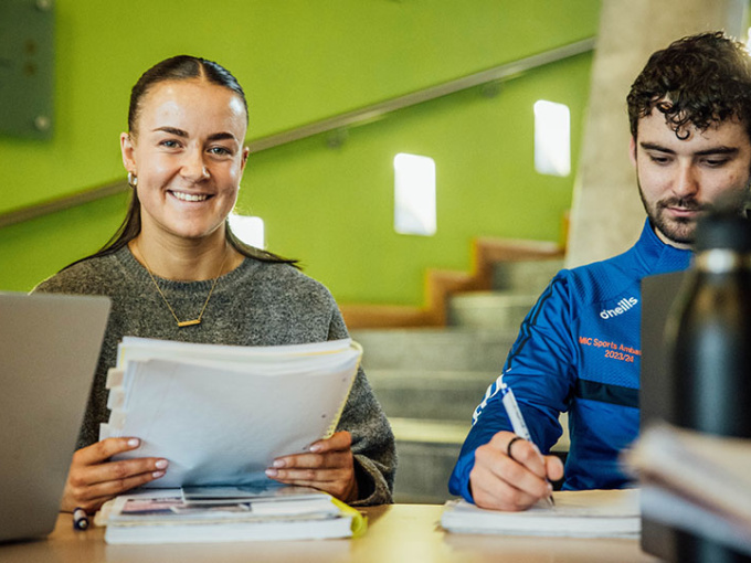 Students sitting at a table in the TARA building.