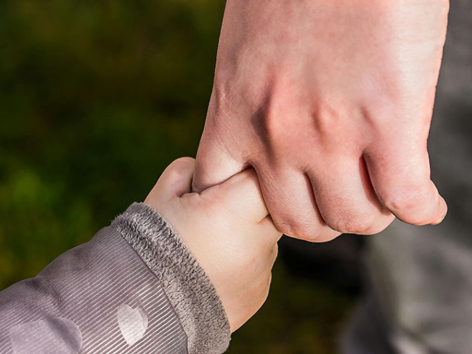 parent and child holding hands