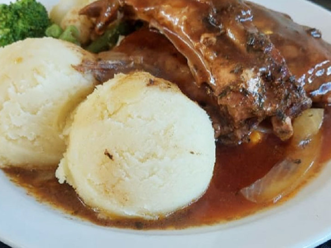 Traditional meat, veg and potato dinner on a white plate